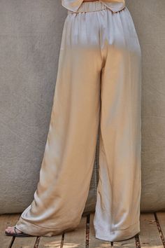 Pearl Pants Satin wide leg trousers in a beautiful pearl color. Very elegant and classic. Elastic in the waist, with clasp and zipper and side pockets. Wear it with the Pearl Blouse or with another top. The fabric is a blend of polyester and spandex, hand wash cold, no bleach, hang dry, no iron. Wide Satin Pants Outfit, Silky Pants Outfit, Silk Trousers Outfit, Satin Trousers Outfit, White Satin Pants, Satin Pants Outfit, Pearl Pants, Modest Pants, Silk Dress Pants