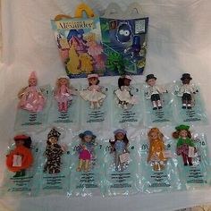 an assortment of dolls in plastic bags on a white sheet with the instructions for each doll