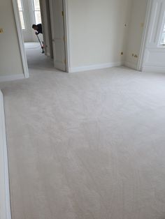 an empty room with carpeted floors and white walls