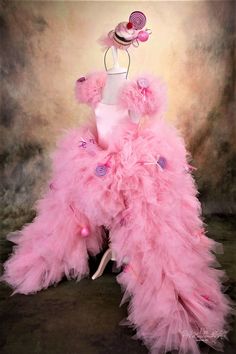 a dress made out of pink tulle and buttons