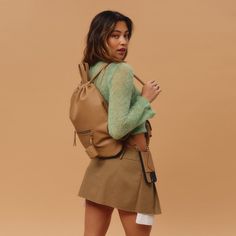 Elevate your daily routine with the Bandolier Drawstring Backpack - a perfect balance of luxury and practicality. The backpack is crafted from the finest, durable pebble leather and features an adjustable leather drawstring opening that cinches to close and open the bag. The classic and timeless silhouette of the backpack is designed to fit a 13-inch laptop, making it perfect for everyday use. Versatile On-the-go Backpack Duffle Bag, Modern Satchel Backpack With Dust Bag, Leather Shoulder Backpack With Adjustable Straps For School, Casual Leather Bucket Bag For School, Leather Satchel Backpack With Adjustable Straps For Daily Use, Modern Gym Bag With Adjustable Strap, Functional Leather Backpack With Removable Pouch, Functional Leather Backpack For On-the-go, Casual Leather Backpack With Adjustable Straps For Daily Use