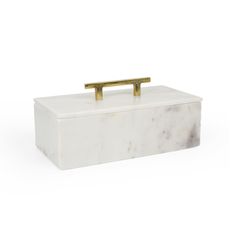 a white marble box with gold handles on the top and bottom, sitting against a white background