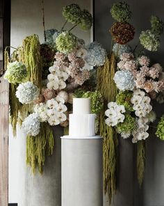 two vases filled with flowers and greenery