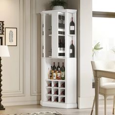 a tall white cabinet with wine bottles in it's bottom shelf and shelves on the side