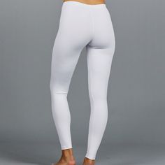 Designer Activewear.Designed and made in Miami.DESCRIPTIONUV Leggings - light solid white legging (SPF 40+ inherent in this finely knit fabric). Intended to be worn underneath any sort of choice.DETAILS & FITAthletic fit, tapered to the body.FABRIC & CARE88% Nylon / 12% SpandexSPF 40+ inherent in fabricMachine wash cold, do not bleach, tumble dry low, cool iron, do not dry clean. White High Stretch Activewear For Pilates, White High-stretch Activewear For Pilates, White Compression Activewear For Pilates, White Seamless High Stretch Activewear, White High Stretch Yoga Activewear, High Stretch White Yoga Activewear, White High Stretch Sporty Yoga Pants, White High Stretch Activewear For Yoga, Sporty High Stretch White Yoga Pants