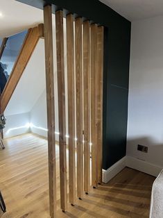 a room with wooden floors and black walls