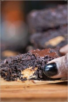 a close up of a piece of chocolate cake on a cutting board with a bite taken out