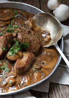 meat and mushroom stew in a large metal bowl