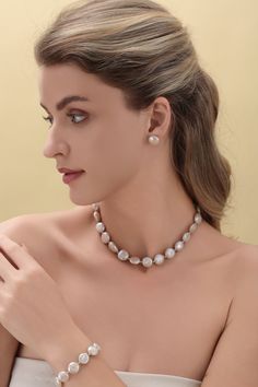 Enhance your elegance with our meticulously handpicked Baroque Freshwater Coin Pearl Jewelry Set." This complete set includes a necklace, bracelet, and earrings, all showcasing the unique charm of 12-14mm coin pearls with exceptional luster. The necklace measures 40cm with an additional 5cm extension, while the adjustable bracelet starts at 16cm. The earrings feature 13-14mm coin pearls, offering a cohesive and sophisticated look. Each piece is crafted from 18K gold-plated materials, emphasizing the pearls' refined beauty. Product Details: Pearl Type: Coin Pearls (Baroque Freshwater Pearls) Pearl Size: 12-14mm (necklace and bracelet), 13-14mm (earrings) Necklace Length: 40cm + 5cm extension Bracelet Length: 16cm, adjustable for longer lengths Earrings Size: 1.5cm Material: 18K Gold Plated Formal Silver Baroque Pearl Jewelry, Classic Baroque Pearl Bead Jewelry, Silver Baroque Pearl Jewelry With Round Beads, Round Baroque Pearl Drop Jewelry, Silver Single Strand Baroque Pearl Jewelry, Formal Baroque Pearl Jewelry In Pearl White, Coin Pearl Necklace, Pearl Jewelry Set, Pearl Jewelry Sets