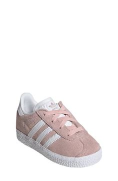 Initially designed in '91 as a training shoe for top athletes, the iconic Gazelle sneaker has been refreshed with stretchy laces for your little athlete. Pull-on style with elastic laces Leather and synthetic upper/textile lining/rubber sole Imported Athleisure Sneakers With White Laces And Round Toe, Athleisure Low-top Sneakers With White Laces, Low-top Athleisure Sneakers With White Laces, Sporty Synthetic Skate Shoes With Elastic Laces, Elastic Lace High-top Sneakers For Jogging, White Non-slip Athleisure Sneakers, Sporty High-top Sneakers With White Laces For Spring, Spring High-top Sneakers With Elastic Laces, Adidas Non-slip Synthetic Sneakers