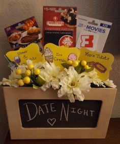 a box filled with flowers and cards on top of a table