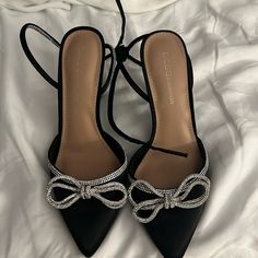 Bcbgeneration Black Heels With Silver Bedazzled Bows And Straps New And Never Worn Size 7.5 Black Heels Silver Bow, Black Ribbon Heels, Black Heel With Bow, Black Heels With Silver Bow, Silver And Black Heels, Pretty Shoes Aesthetic, Pretty Heels Prom, Black Hoco Heels, Black Heels For Prom