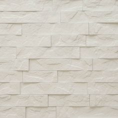 a white brick wall textured with natural stone