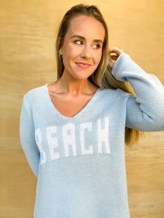 Get cozy with this beachy light blue sweater. Featuring a playful white print that reads "beach," this sweater is perfect for lounging by the ocean or just adding some seaside vibes to your look. Stay warm and stylish with this quirky piece! Ashley is 5'4" and is wearing a size medium. Beach Sweater, By The Ocean, Light Blue Sweater, Blue Sweater, Getting Cozy, Dress Romper, Clothes Collection, Sweater Blouse, Blue Sweaters