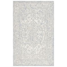 a white rug with blue and grey designs on the bottom, in an ornate pattern