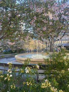 a fountain surrounded by trees and flowers