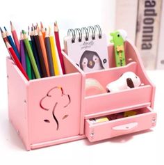 a pink desk organizer with pens, pencils and markers