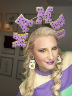 Wearing this lightweight halo will have you singing Mardi Gras Mambo up and down the parade route! Purple letters with a sparkly gold outline and jewels are just what you need to catch all of the beads! Due to the handmade nature of this product, each design will look ever so slightly different. Fun Gold Jewelry For Party, Party Jewelry With Gold Letter Beads, Trendy Gold Festive Jewelry, Trendy Gold Jewelry For Festive Occasions, Fun Gold Jewelry For Summer, Fun Gold Summer Jewelry, Playful Beaded Gold Jewelry, Fun Customizable White Jewelry, Customizable Fun White Jewelry