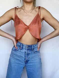 Our Tara top has a flattering split detail with adjustable tie up straps! Perfect for summer! 55% Cotton, 45% Polyester Model is wearing a size Small (Height: 5'3, Waist: 25, Hips: 32, Bust: 32A) Easy Sew Crop Top, Diy Satin Top, Crop Top En Satin, Silk Top Outfit, Crop Top Diy, Crop Top Satin, Unique Sewing Patterns, Trendy Sewing Patterns, Silk Crop Top