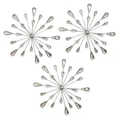 four silver spoons are arranged in the shape of a snowflake on a white background