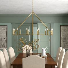 a dining room table with white chairs and a chandelier hanging from the ceiling