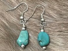 Beautifully Handmade Native American Indian Jewelry Navajo RARE Nevada Turquoise Silver balls Dangle Earrings.  Handcrafted by Navajo Artist F. Sellers.  Perfect for a gift❤️ Turquoise, or "Doo tl' izh ii" in Navajo, holds a very special significance in several Native American cultures, especially for the Navajo people. This semi-precious gemstone that is often called the "stone of life" is currently well-known because of the popularity of Navajo turquoise jewelry, but it has a long and fascinat Handmade Western Turquoise Earrings, Handmade Western Dangle Earrings, Western Turquoise Nickel-free Earrings, Western Turquoise Dangle Earrings, Western Style Turquoise Nickel-free Earrings, Turquoise Nickel-free Western Earrings, Western Style Nickel-free Turquoise Earrings, Turquoise Dangle Earrings Western Style, Southwestern Turquoise Earrings With Natural Stones