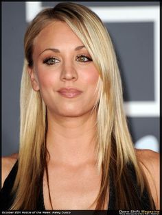 a woman with long blonde hair and green eyeshadow at an awards event, looking into the camera