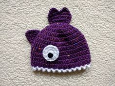 a crocheted hat with an eye on it