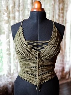 a mannequin is wearing a crocheted halter top