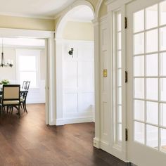 a dining room table and chairs in front of an open door