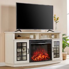 an entertainment center with a fireplace and flat screen tv