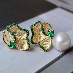 💚💚 Specifics: Materials: Natural freshwater Pearl With 925 Silver And Zircon Earrings Size: 12mm*22mm Pearl Diameter: 10mm*10mm Closure: the closure is made of 925 sterling silver.  Handmade Artwork, original design and copyright protected  Metal: Gold plated s925 silver 💚💚Shipping We ship it in 5-7 days after the payment is made and you may choose your personalized shipping services. We shipping world wide and it is free international shipping. Please kindly be reminded that we are not resp Elegant Green Round Bridal Earrings, Elegant Green Flower Shaped Jewelry, Elegant Green Flower-shaped Jewelry, Green Cubic Zirconia Flower-shaped Jewelry, Elegant Green Crystal Earrings As Gift, Elegant Green Crystal Earrings For Gift, Green Gold-plated Bridal Earrings As Gift, Elegant Green Round Clip-on Earrings, Elegant Gold Plated Green Bridal Earrings