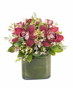 Burgundy cymbidium orchid blooms in a petite low, cube vase. Lovely for a coffee table or desk.  
 thanksgiving Cymbidium Orchid, Central Square, Cymbidium Orchids, Boston Ma, Fall Flowers, In Boston, A Coffee, Florist, Orchids