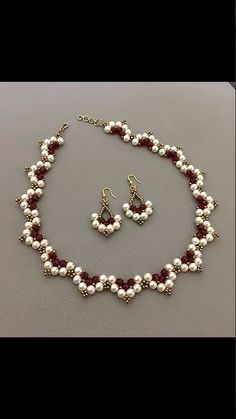 a necklace and earring set with pearls, garnets and red glass beads