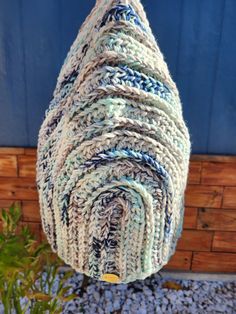 a blue and white bag hanging from a rope