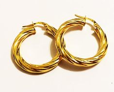 Fancy swirly hoop earrings:metal       : solid 14k yellow goldweight     = 2.2 grdiameter = 1"inch (23mm)thick        = 4 mmclosure    : snap-downmade       : in Italy Elegant Spiral Hoop Earrings As Gift, Elegant Spiral Hoop Earrings For Gift, Trendy Yellow Gold Hoop Earrings For Anniversary, Trendy Yellow Gold Hoop Earrings For Formal Occasions, Elegant Cadmium-free Hoop Earrings As Gift, Elegant Twisted Hoop Earrings Gift, Trendy Hoop Jewelry For Anniversary, Elegant Twisted Hoop Earrings, Elegant Hypoallergenic Hoop Earrings As Gift