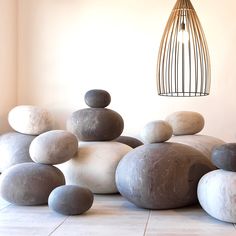 several rocks stacked on top of each other in front of a caged light fixture