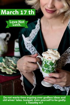 a woman holding a cup with whipped cream in it and looking at the camera while wearing a green robe