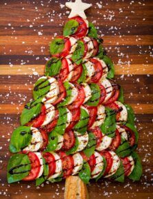 a christmas tree made out of tomatoes and mozzarella on a skewer