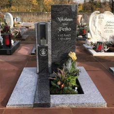 a cemetery with headstones and flowers on the ground