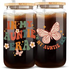 two large jars filled with liquid and some butterflies on the top one is labeled in my favorite era