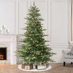 a living room with a christmas tree and fireplace