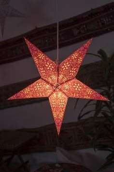 an origami star hanging from the ceiling