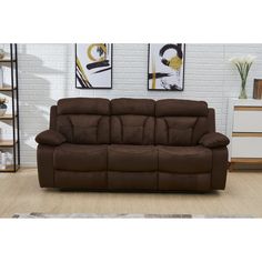 a brown reclining couch sitting on top of a wooden floor