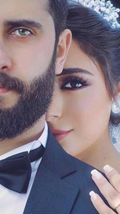 a man with a beard wearing a tuxedo next to a woman in a wedding dress