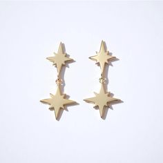 Fine Essentials - Double star dangle earrings | Sleepy Mountain Gold Drop Earrings With Star Charm, Gold Star Earrings Tarnish Resistant, Gold Star-shaped Tarnish Resistant Earrings, Gold Starburst Single Earring, Gold Earrings With Star Charm, Gold Sterling Silver Earrings With Star Charm, Gold Star-shaped Celestial Earrings, Gold Starburst Celestial Earrings, Star-shaped 14k Gold-filled Earrings