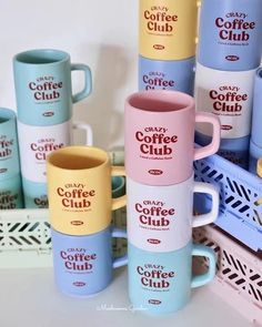 several coffee mugs stacked on top of each other with the words crazy coffee club printed on them