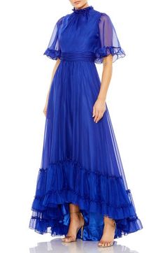 A brilliant blue gown serves so much swish from the frilly, full sleeves to the ruffle-decked, high-low hemline Ruffled jewel neck Short sleeves Lined, except sleeves 100% polyester Spot clean Imported Asian Owned/Founded Blue Wedding Dress With Ruffle Hem, Blue Ruffled Evening Dress For Gala, Long Sleeve Gown With Ruffles, Blue Floor-length Gown With Ruffles, Royal Blue Ruffled Evening Dress, Blue Ruffled Gown For Gala, Blue Maxi Gown With Ruffles, Blue Ruffled Maxi Length Gown, Blue Ruffled Maxi Length Evening Dress