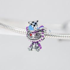 This is charm only, bracelet is sold separately.The charm features Alice in Wonderland's Cheshire cat character with its distinctive mischievous grin, made of solid 925 sterling silver and enamel color decoration. Add this charm to your charm for bracelet collection or as gift for your love one. The Cheshire Cat charm is a delightful addition to your bracelet collection, showcasing the playful spirit of Alice in Wonderland. Made of high-quality 925 sterling silver and adorned with vibrant enamel Whimsical Silver Charms For Gifts, The Cheshire Cat, Color Decoration, Cat Character, Cat Charm, Cheshire Cat, For Your Love, Silver Charm Bracelet, Bracelet Collection