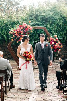 a bride and groom walking down the aisle